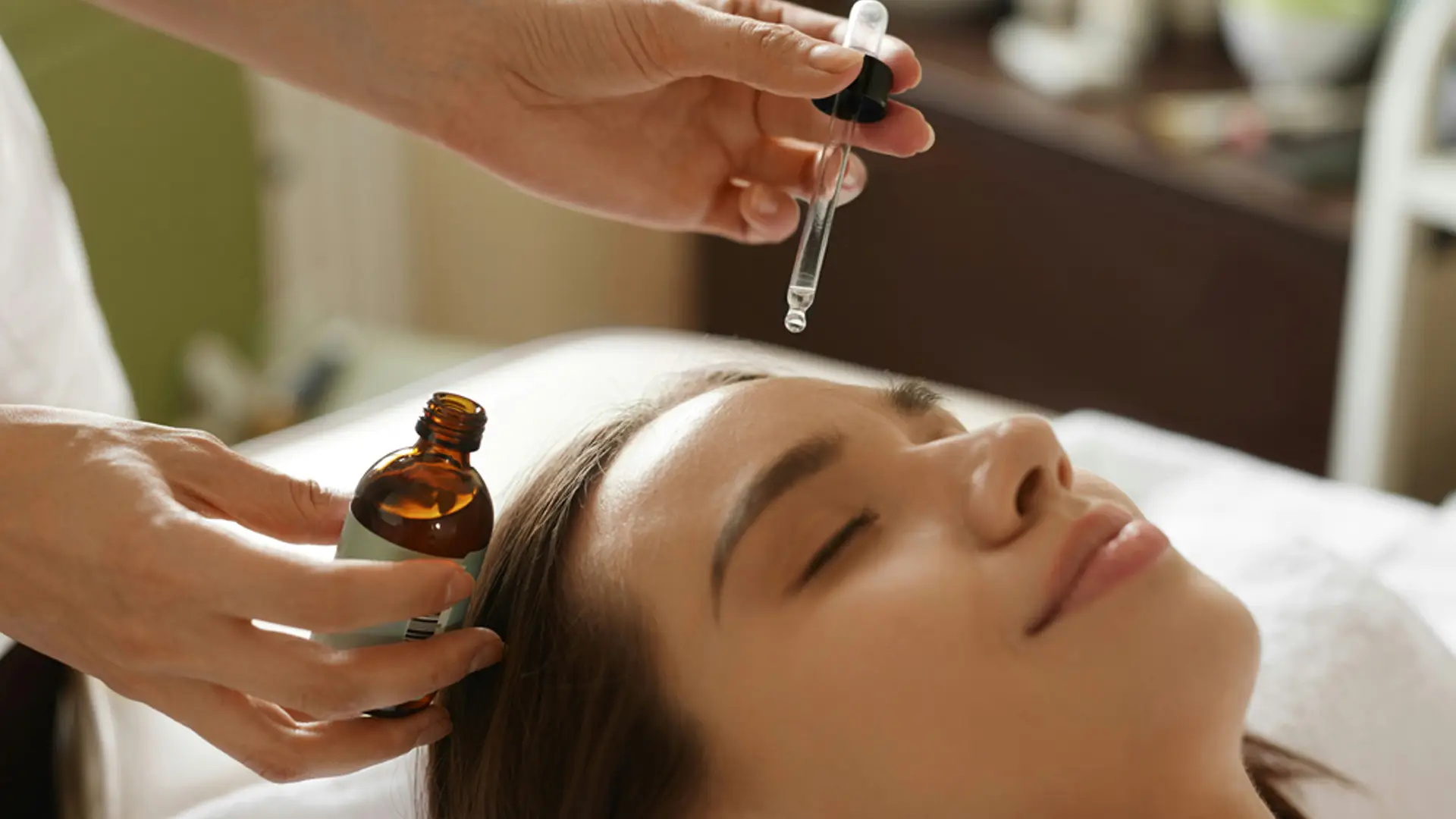 A woman receiving a Raindrop Technique treatment.